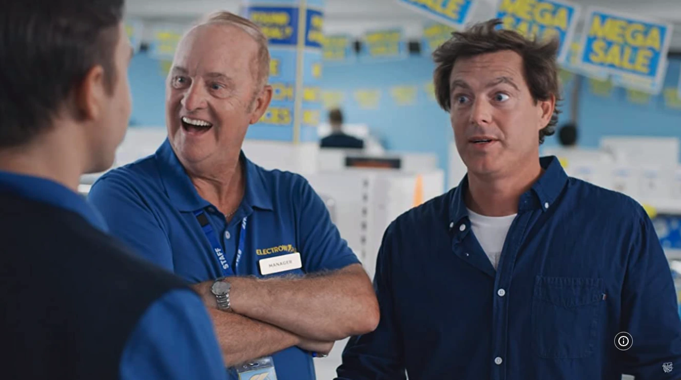 Paul Moore shares a laugh with Rostered On co-stars during filming — authentic moments of Australian comedy in action.