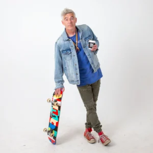Paul Moore as Bates holding a skateboard during promo photography for Stashamo High feature film.