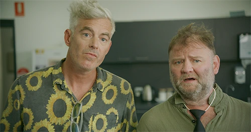 Paul Moore performing in a kitchen scene from Stashamo High as substitute teacher Bates, caught in another unlucky twist.