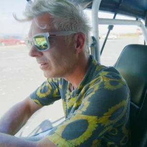 Paul Moore as Master Bates in Stashamo High, driving to school in his iconic car.