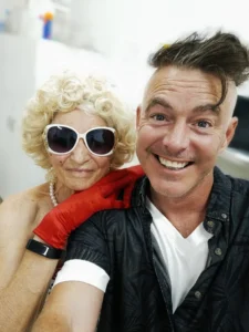 Paul Moore with his mum at a Geelong dress-up celebration, sharing a joyful moment that reflects family, creativity, and community spirit.